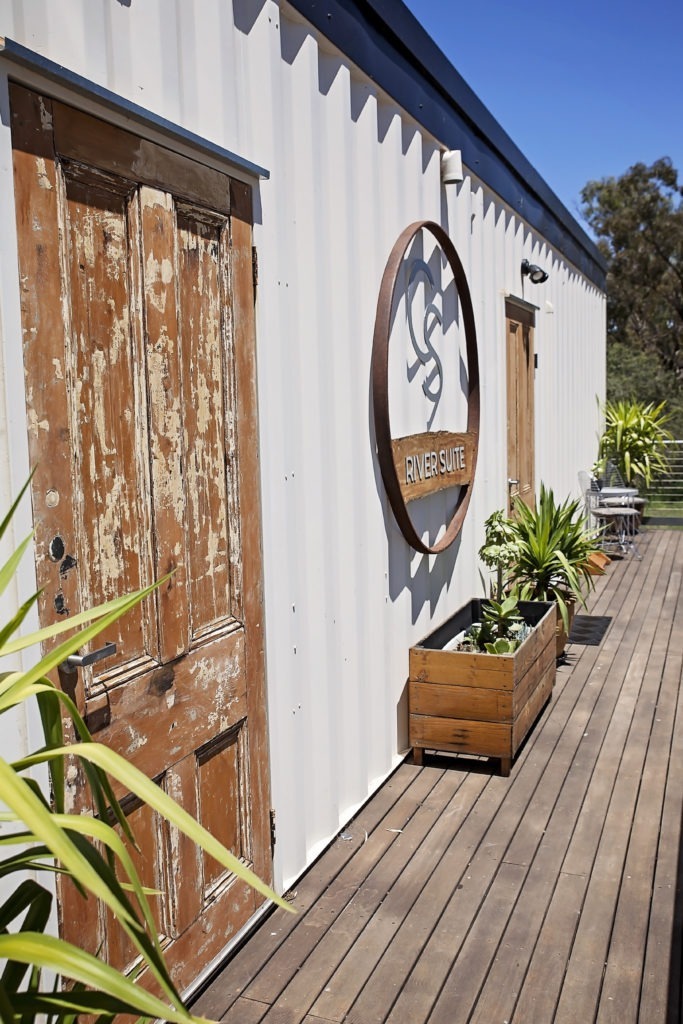 River Suite entrance with weathered timber door and circular signage at Callubri Station.