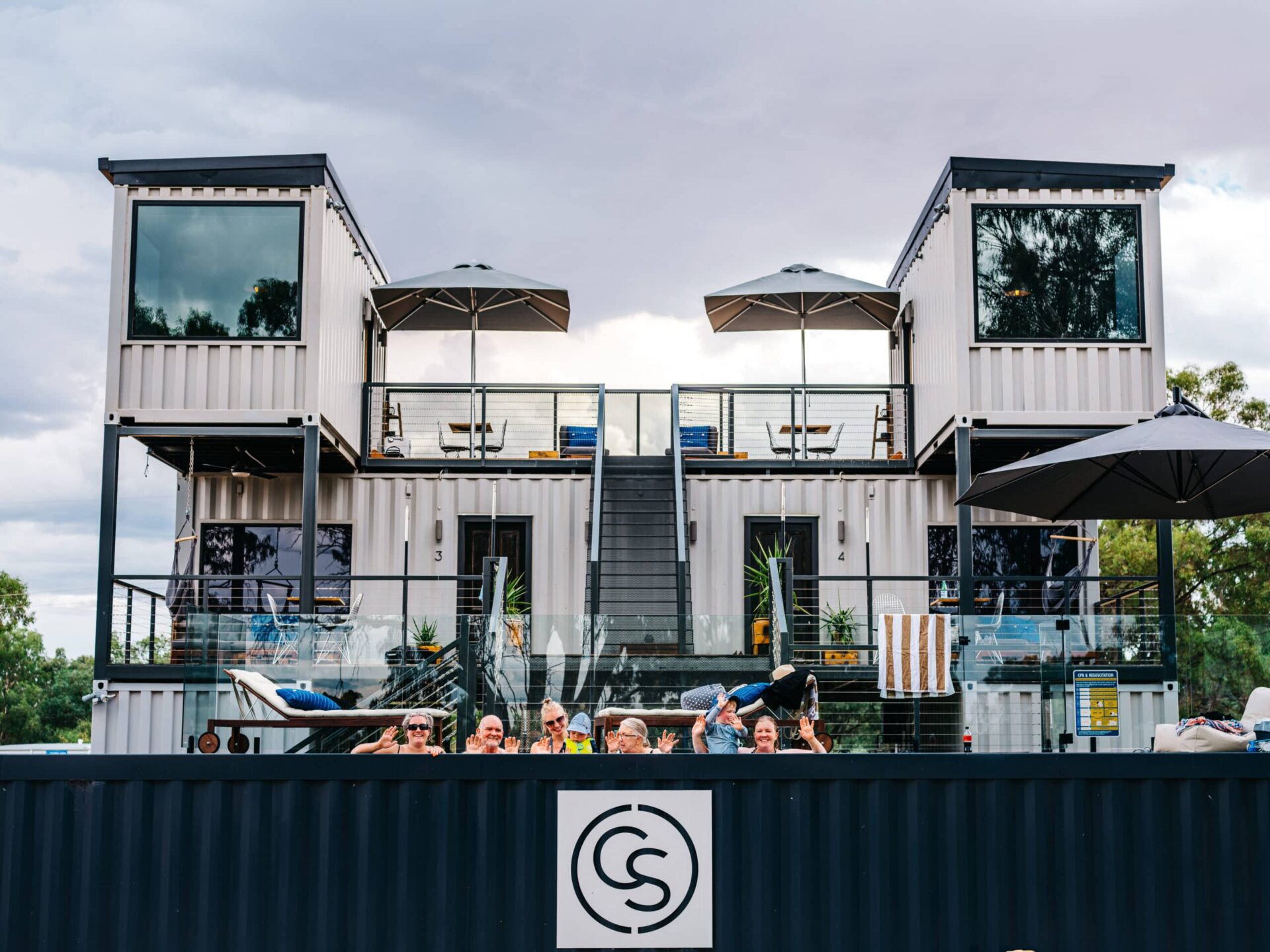 Guests relax at Callubri Station's Sky Suites with mineral pool views and umbrellas.