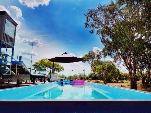 Callubri Station's heated mineral pool with float lounges and outback NSW landscape views.