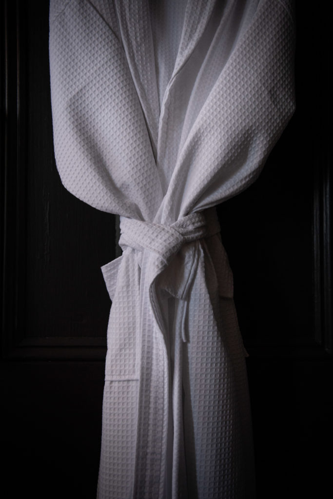White waffle-weave robe with tied belt, luxury accommodation detail at Callubri Station.