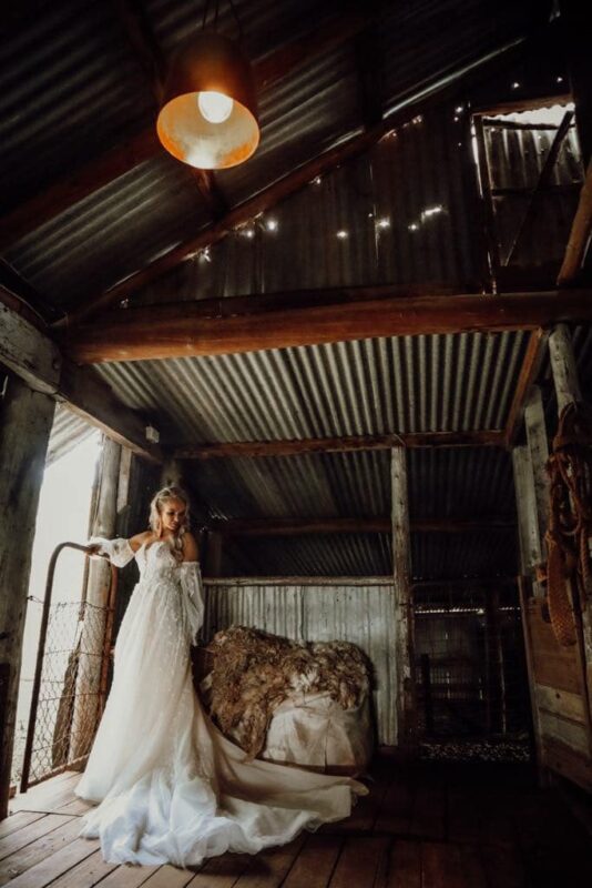 Bride in white gown inside rustic shearer's quarters at Callubri Station.