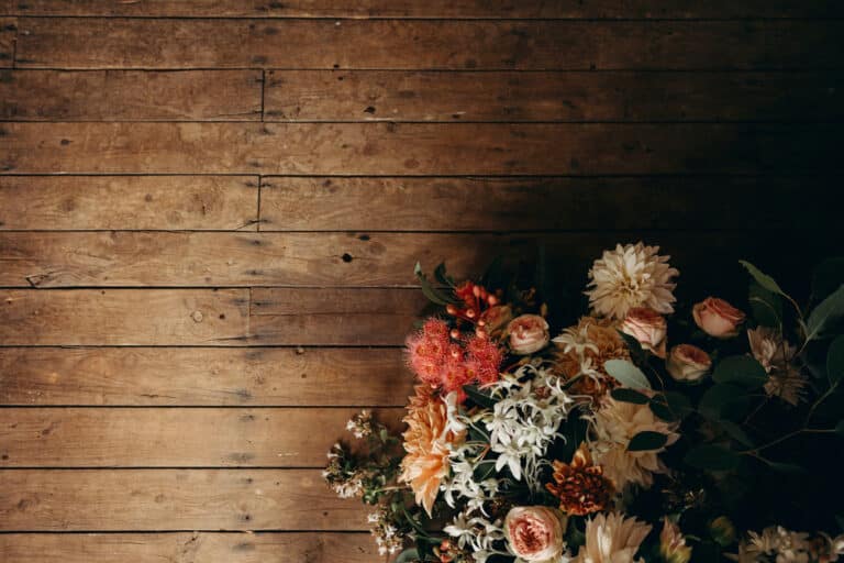 Rustic wooden flooring with autumn floral arrangement for Callubri Station outback accommodation.